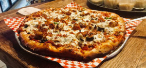 fresh pizza on serving tray landsharks niceville