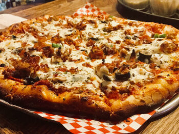 fresh pizza on serving tray landsharks niceville